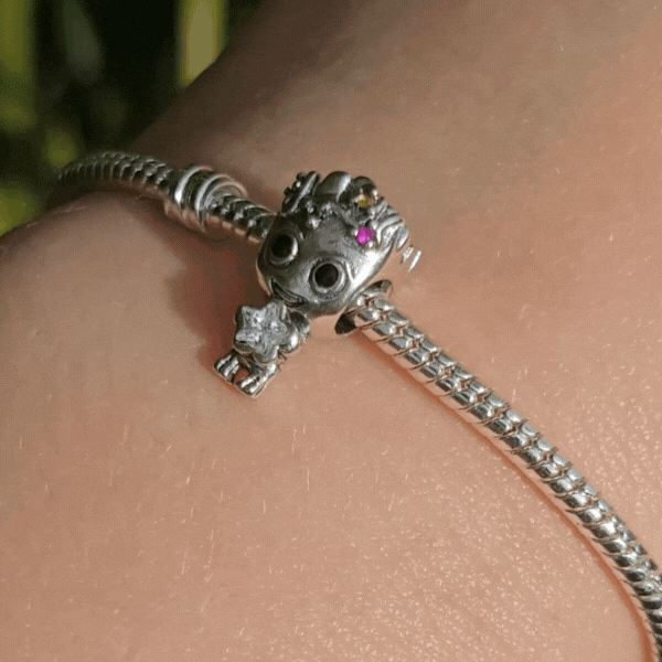 Ajoutez une touche festive et adorable à votre collection avec ce charm Groot en mode Noël. Fabriqué en métal argenté avec des accents de couleur en émail rouge et vert, ce charm représente Groot, le célèbre personnage des Gardiens de la Galaxie, enveloppé dans une guirlande de Noël scintillante, prêt à célébrer les fêtes. Les détails minutieux capturent son expression malicieuse et son côté espiègle, parfait pour les fans de Marvel et de la magie de Noël. Compatible avec les bracelets Pandora, ce charm uni