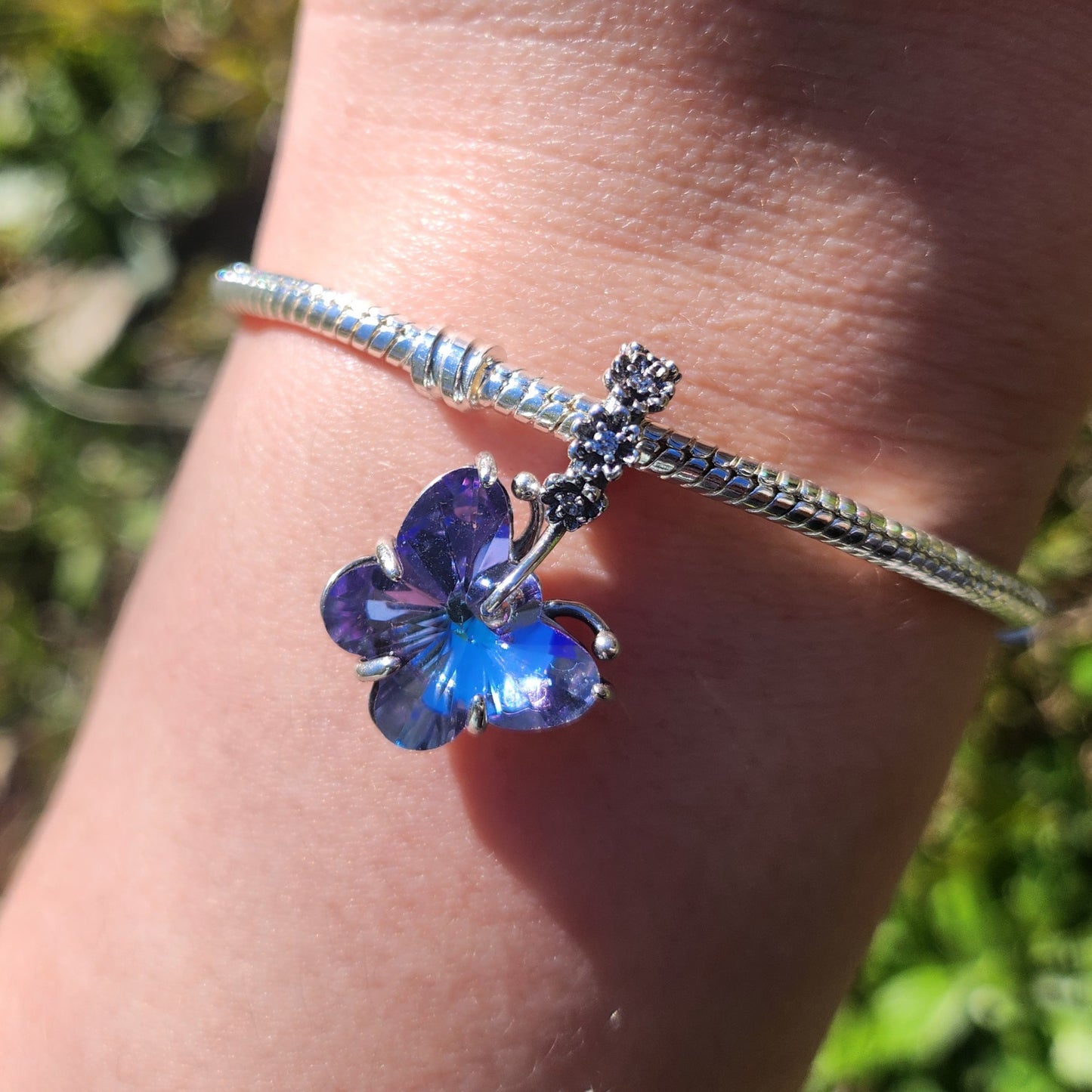 Capturez la magie des rêves avec le charm Papillon Bleu et Violet, conçu en argent 925 avec des détails émaillés dans des tons doux et mystiques. Ce bijou symbolise la transformation et la sérénité, idéal pour rehausser votre bracelet avec élégance.