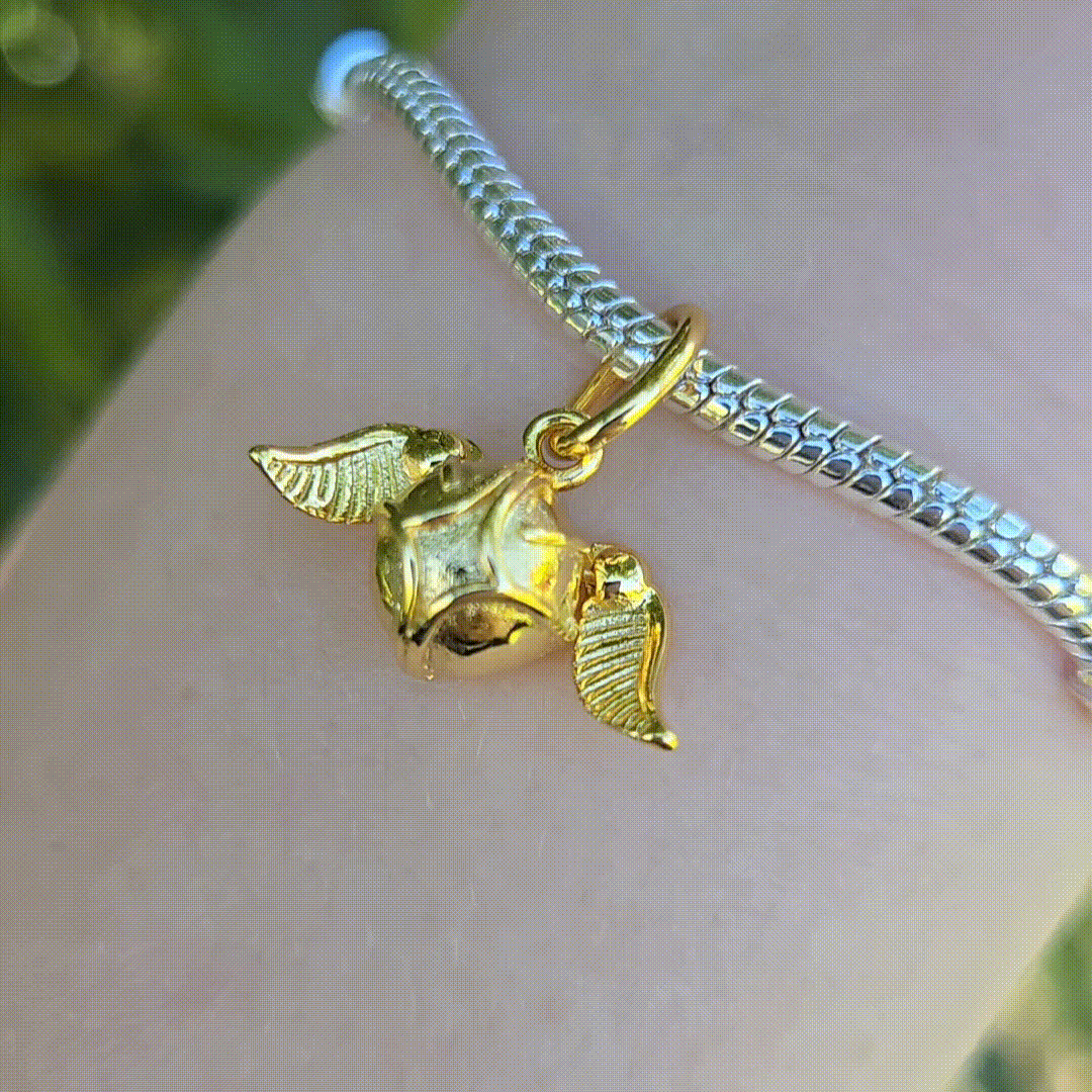Capturez l'essence de l'univers magique de Harry Potter avec ce charm pendentif étincelant en forme de Vif d'Or. Fabriqué en argent sterling 925, ce charm de haute qualité brille de mille feux grâce à ses détails lumineux et sa finition brillante. Symbole emblématique du Quidditch, le Vif d'Or est reconnu pour sa rapidité et son importance cruciale dans le jeu. Ce pendentif est idéal pour les passionnés de Harry Potter qui souhaitent ajouter une touche d'éclat et de magie à leur collier ou bracelet.