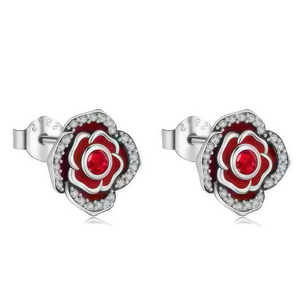 Ces boucles d’oreilles puces en argent 925 dessinent une rose stylisée, dont les pétales sont soulignés d’émail rouge profond pour un effet velouté et intense. Au cœur de chaque fleur brille une pierre rouge facettée, entourée d’un halo de petits zirconias clairs qui ajoutent une touche de lumière tout autour du motif.

Caractéristiques :

-Matière : Argent 925 avec émail rouge et zirconias clairs et rouges.
-Design : Fleur de rose en plusieurs couches de pétales, centrée par une pierre rouge et cerclée de 