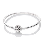Ce bracelet en argent 925 est orné d’un fermoir en forme de fleur stylisée, façon mandala, dont le centre pavé de zircones illumine délicatement le poignet.
Porté seul pour un look minimaliste chic ou agrémenté de charms de type européen, il devient une base élégante pour composer un bijou personnalisé.