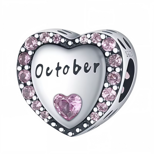 Embrassez le mois d’octobre avec ce charm en argent 925 en forme de cœur, délicatement orné d’un contour de strass roses éclatants. Au centre, l’inscription « October » est gravée avec finesse, sublimée par une pierre rose en forme de cœur qui symbolise la compassion et la douceur automnale. Un bijou parfait pour célébrer un anniversaire d’octobre ou offrir un cadeau élégant et chargé de sens.