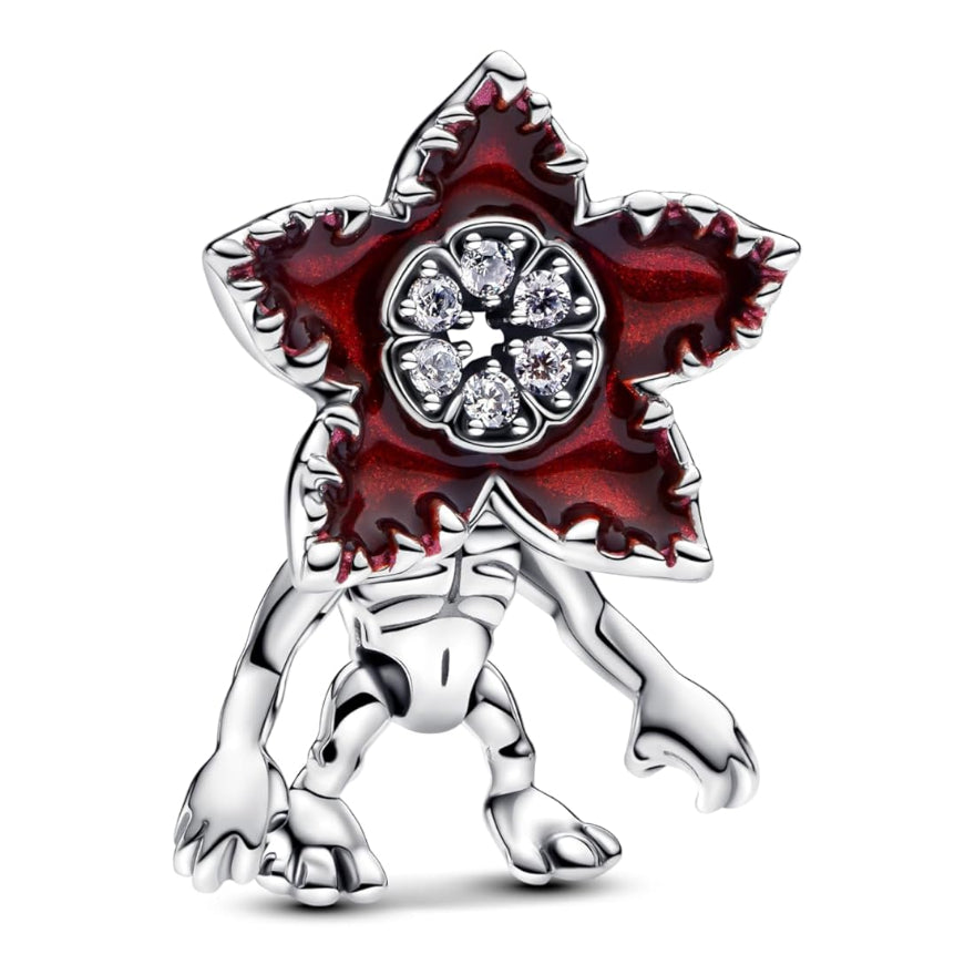 Charm monstre fleur en argent 925, au visage en forme de corolle rouge sombre dentelée, ornée de plusieurs oxydes de zirconium clairs qui rappellent un cœur de fleur scintillant. Compatible avec les bracelets de type Pandora, il se glisse facilement sur la plupart des bracelets à maillons ou rigides pour ajouter une touche dark-fantasy à votre composition.