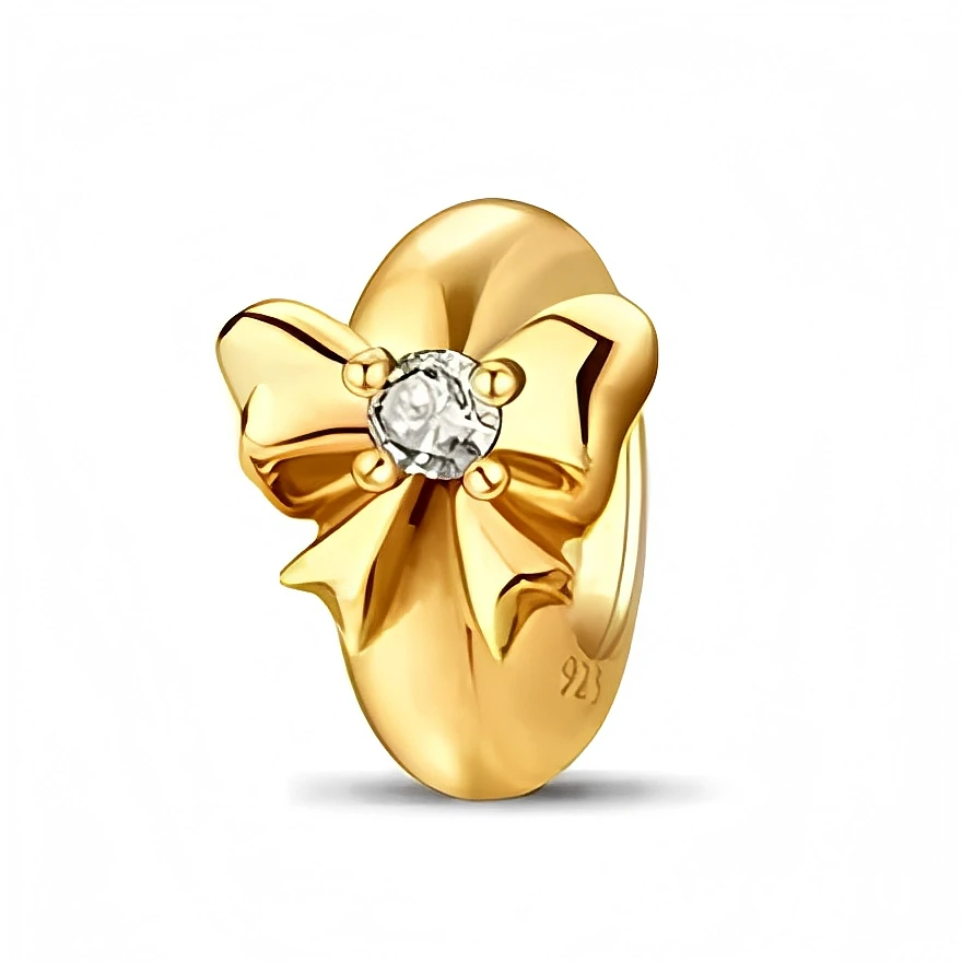 Ce charm en argent 925 met en avant un petit nœud délicat, entièrement lisse et brillant, dont les plis sont soulignés par un joli volume. En son centre, une pierre ronde claire façon cristal apporte une touche lumineuse qui en fait un bijou discret mais raffiné pour toutes les saisons.

Caractéristiques :

Matière : Argent 925 avec pierre synthétique transparente.
Design : Fin nœud ruban stylisé, centré par un cristal rond.
Coloris : Doré chaud, éclat transparent.
Compatibilité : Convient à la plupart des 