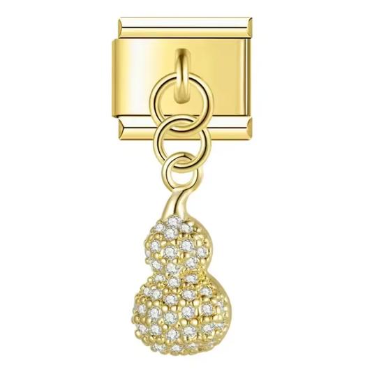 Ce charm italien pendentif original représente une cacahuète dorée, symbole de gourmandise et d’originalité. Confectionné en acier inoxydable de haute qualité avec une finition dorée brillante, il offre un design finement travaillé et élégant. Facile à fixer, il se balance légèrement pour apporter du mouvement et une touche ludique à votre bracelet composé de 17 maillons extensibles et réglables. Compatible avec tous nos charms italiens, ce bijou est idéal pour compléter votre collection avec une note gourm