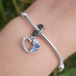 Ajoutez une touche de romance et de couleur à votre collection avec ce charm en forme de cœur orné de strass blancs et d’un papillon bleu. Confectionné en argent sterling S925, ce charm combine élégance et éclat, capturant la beauté délicate du design.

Les strass blancs ajoutent un éclat raffiné, tandis que le papillon bleu apporte une touche de couleur vibrante et de légèreté.