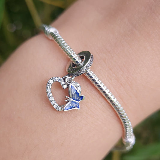 Ajoutez une touche de romance et de couleur à votre collection avec ce charm en forme de cœur orné de strass blancs et d’un papillon bleu. Confectionné en argent sterling S925, ce charm combine élégance et éclat, capturant la beauté délicate du design.

Les strass blancs ajoutent un éclat raffiné, tandis que le papillon bleu apporte une touche de couleur vibrante et de légèreté.
