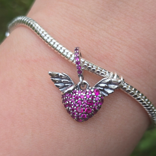 Symbolisez liberté et amour avec ce charm Cœur avec des Ailes. En argent 925, il est parfait pour illustrer vos rêves et vos émotions.