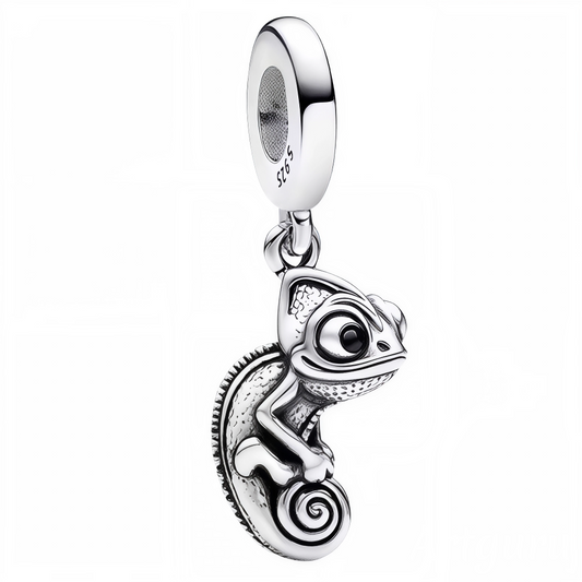 Ajoutez une note d’originalité subtile à votre collection avec ce charm pendentif en forme de caméléon, finement travaillé dans une finition argentée brillante. Symbole d’adaptabilité et de mystère, ce petit reptile s’enroule délicatement dans une posture réaliste et élégante. Avec ses détails finement sculptés, ce bijou allie raffinement et exotisme pour un effet à la fois discret et captivant.