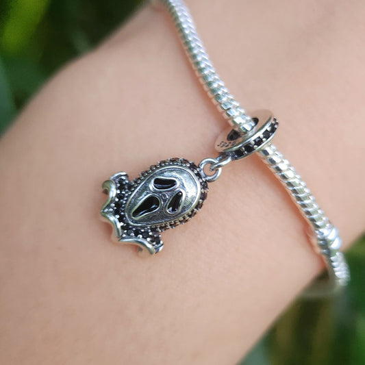 Ajoutez une touche d'horreur iconique à votre collection avec le Charm - Ghostface de la saga Scream, en argent sterling S925. Ce charm représente le célèbre tueur masqué de la série de films d’horreur culte, Ghostface, dans son style sinistre et effrayant. Parfait pour les amateurs de films d'horreur et de frissons, ce charm est idéal pour compléter un look audacieux et mystérieux.