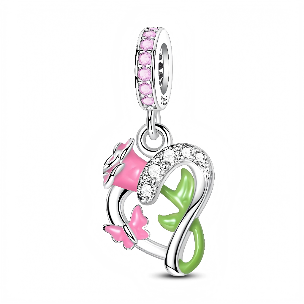 La bélière en argent 925 est sertie tout autour de petites pierres roses scintillantes, apportant une touche très féminine. Le pendentif représente une rose émaillée rose insérée dans un cœur partiellement pavé de zircons clairs, avec une tige verte et un petit papillon rose posé sur le côté.