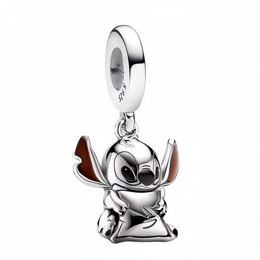 Craquez pour la tendresse et la douceur incarnées par ce charm pendentif en argent 925 représentant Stitch assis, serrant un petit coussin contre lui. Avec son allure câline et ses détails soignés, ce bijou plein d’émotion apportera une touche réconfortante et attachante à votre collection. Parfait pour les amateurs de Disney et les amoureux de bijoux sensibles et expressifs.