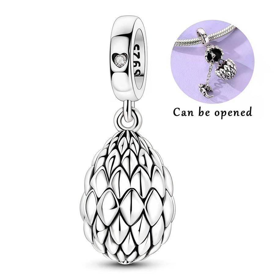 Charm pendentif mystérieux représentant un œuf de dragon finement travaillé en argent 925, renfermant un petit dragon à l’intérieur. Son design détaillé, inspiré des écailles et de l’univers fantastique, en fait une pièce originale et pleine de caractère. Un bijou idéal pour les amateurs de dragons, de fantasy et de créatures légendaires.

Caractéristiques :

- Matière : Argent 925.
- Design : Œuf de dragon détaillé avec un petit dragon à l’intérieur.
- Style : Fantastique, mystérieux et élégant.
- Symboliq
