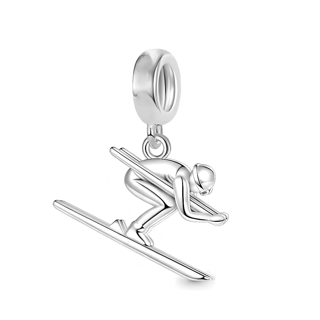 Ce charm pendentif&nbsp;aventureux&nbsp;illustre un skieur en plein saut acrobatique, sculpté en argent sterling poli avec une pose dynamique penchée en avant sur une planche de ski effilée. La silhouette fine capture le casque arrondi, les bâtons tenus fermement et les jambes fléchies pour l’atterrissage, évoquant vitesse et adrénaline sur les pistes enneigées. Les détails précis comme les lignes de la combinaison et la courbe de la planche ajoutent du réalisme, tandis que l’anneau supérieur poinçonné « S9
