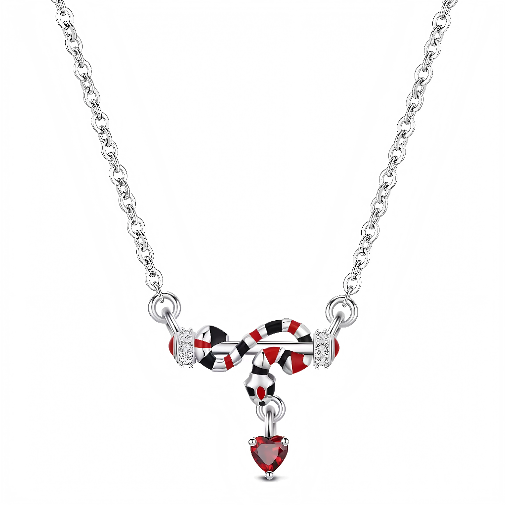 Ce collier en argent 925 met en scène un serpent stylisé aux anneaux émaillés rouge, blanc et noir, suspendu au centre de la chaîne. Un petit cœur rouge facetté pend au bout de sa queue, apportant une touche sensuelle et mystérieuse idéale pour un look affirmé.

Caractéristiques :

-Matière : Argent 925/1000 massif pour la chaîne et le motif, anneaux du serpent émaillés de rouge, blanc et noir, cœur final en cristal synthétique rouge taille cœur, petits cristaux transparents sur les côtés.
-Design : Pendent