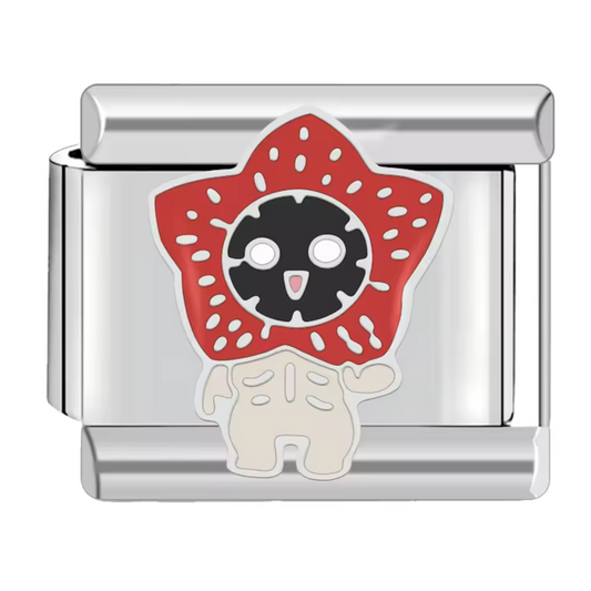 Ce charm italien représente le terrifiant Démogorgon de Stranger Things, idéal pour les fans de la série culte. Fabriqué en acier inoxydable de haute qualité, il combine robustesse et détails soignés pour un rendu fidèle au célèbre monstre. Ce charm s’attache facilement à nos bracelets composés de 17 maillons extensibles et réglables, qui s’adaptent à toutes les tailles de poignet. Entièrement compatible avec tous nos charms italiens, il est parfait pour personnaliser votre bijou avec une touche geek et ori